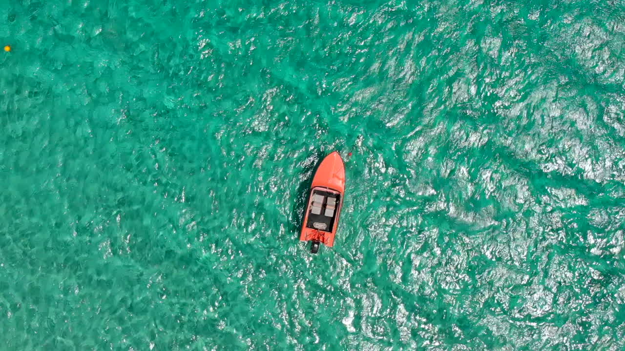 Orange boat moving on the sea in Cyprus