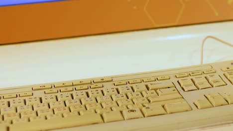 a detailed view of a wired keyboard placed on a light-colored desk surface.