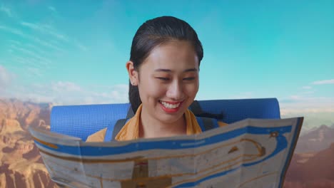 close up of asian female hiker with mountaineering backpack looking at the map then looking around while traveling at the top of mountain