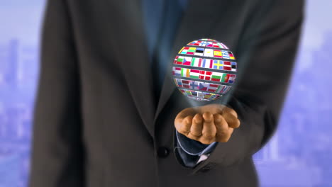 ball made of european nationals flags turning on businessman hands