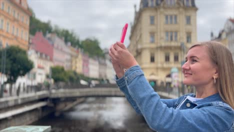 mujer tomando una foto de un paisaje urbano