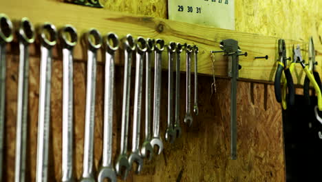 human hand hangs on wall vernier caliper.