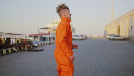 Worker-in-orange-uniform-is-running-in-the-harbour.-Slow-Motion-shot