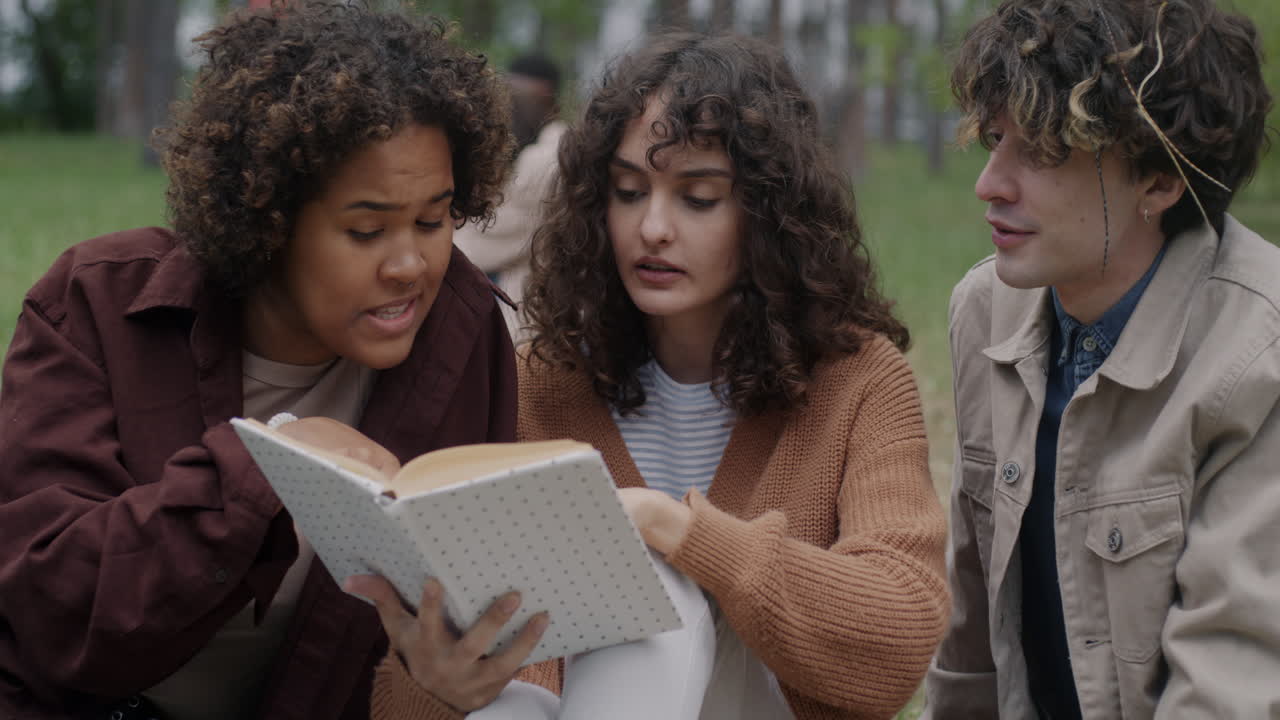 Friends Reading Together in a Park