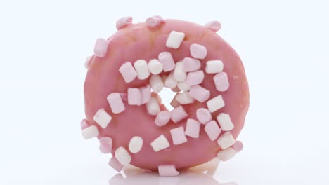 pink glazed marshmallow donut. bright and colorful sprinkled donut on a white background. assortment of donuts of different flavors