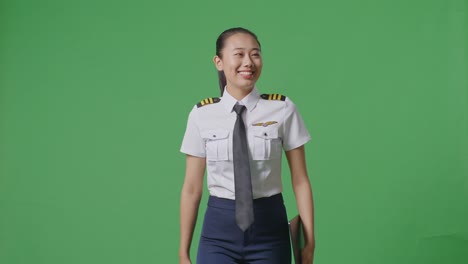 female pilot in uniform on green screen