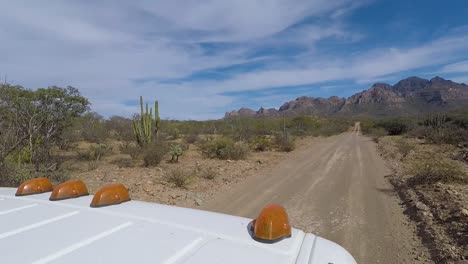 Road-Trip---Vehicle-on-Dirt-Road-in-Wide-Open-Spaces-of-Mexico-Desert