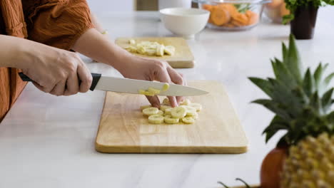 mom and boy cutting bananas.