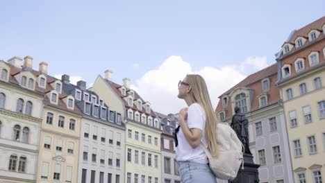 a woman explores a vibrant city capturing its architecture and culture a woman explores a vibrant city with a backpack admiring grand architecture and notable statues engaging with cultural landmarks in her adventure