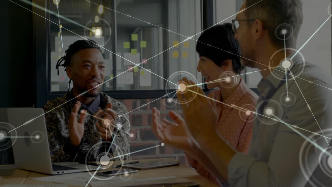 Animation of network over happy diverse colleagues clapping at casual office meeting