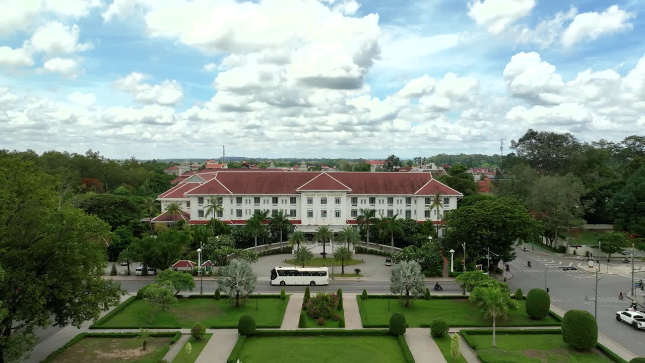 Elegant white hotel with red roof in tropical Siem Reap, Cambodia, sunny calm vibe