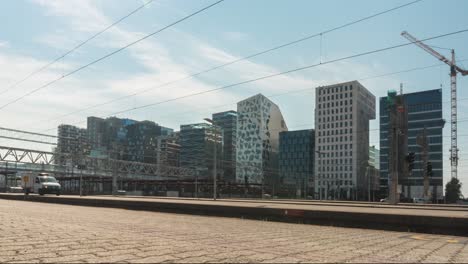 time lapse of busy oslo city centre train station, modern utopia city life