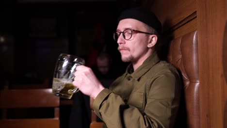 man drinking beer in a bar