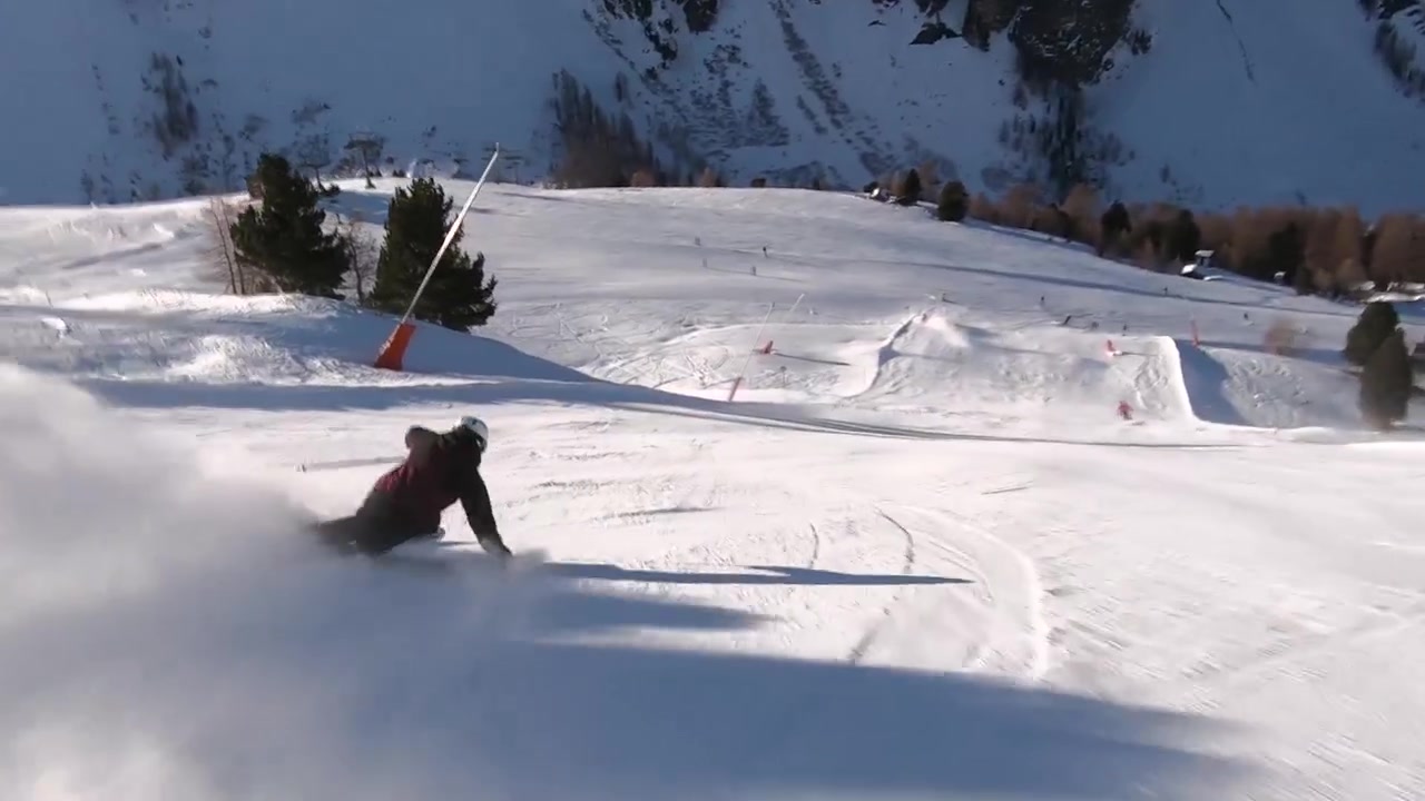 Skiing race turns on a steep ski slope. High speed skiing in the tirolean mountains with skirace equipment. Slomotion sixty frames per second.