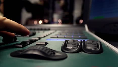 male hands using sound and light digital mixer at a concert 1