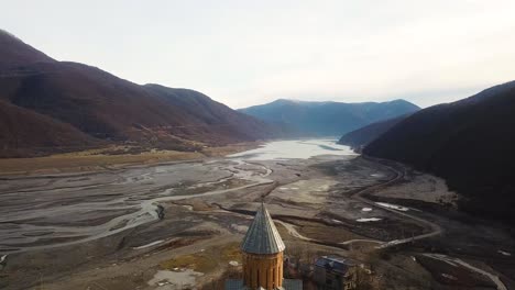 Drone-crash-accident-during-the-recording-video-footage-capture-the-beautiful-nature-landscape-in-a-river-side-chapel-catholic-church-before-Christmas-mountain-view-in-Iran-Azerbaijan-Turkey-travel