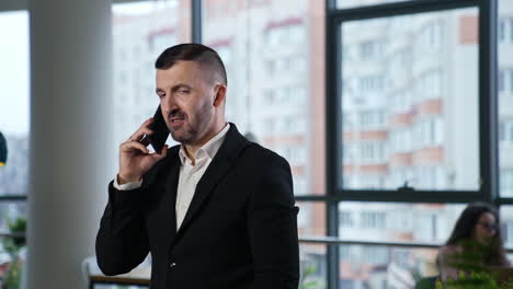 businessman talking on the phone in a cafe