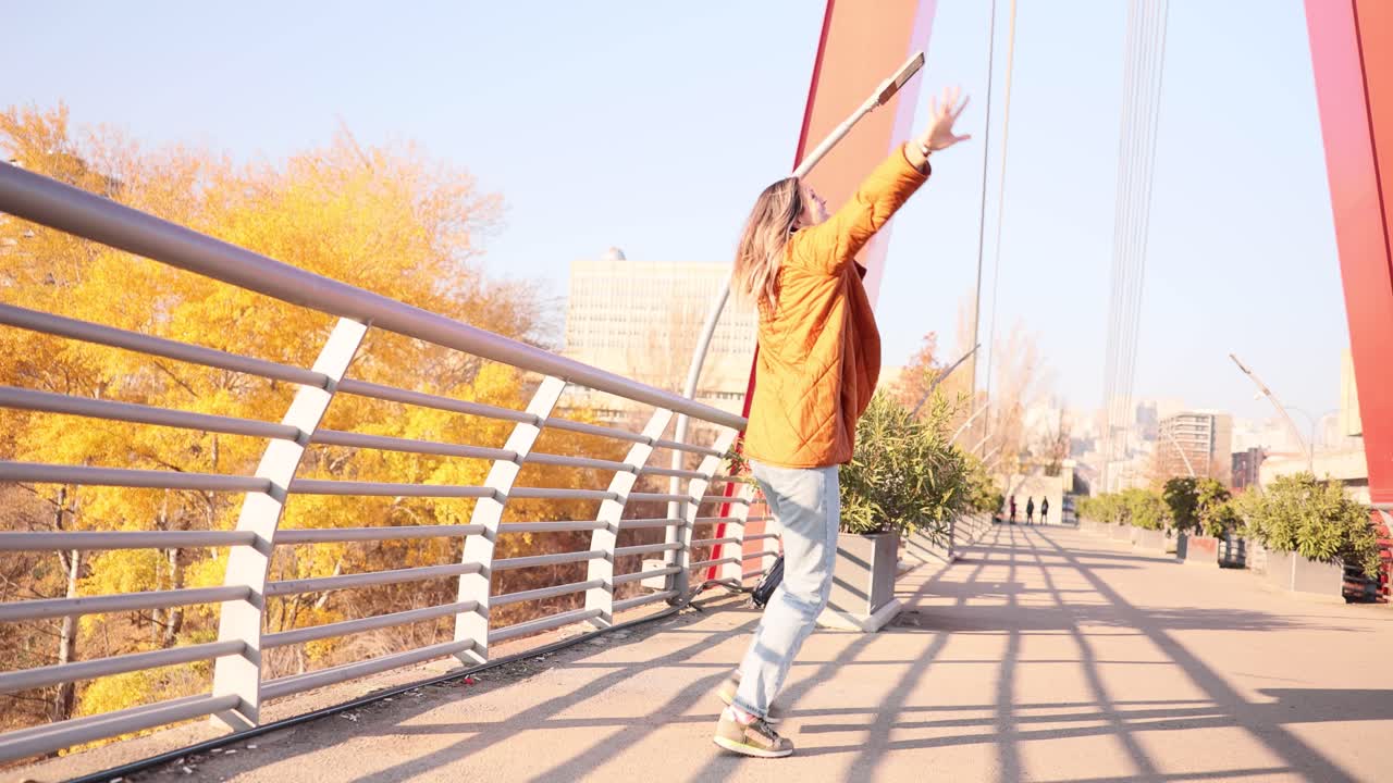 Woman walking on a bridge in autumn
