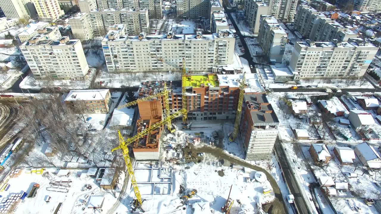 Construction site with cranes. Under construction high-rise building with construction cranes