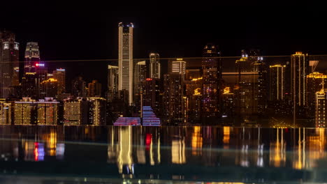 Timelapse of the amazing Chongqing cyberpunk city skyline reflected in a pool at night