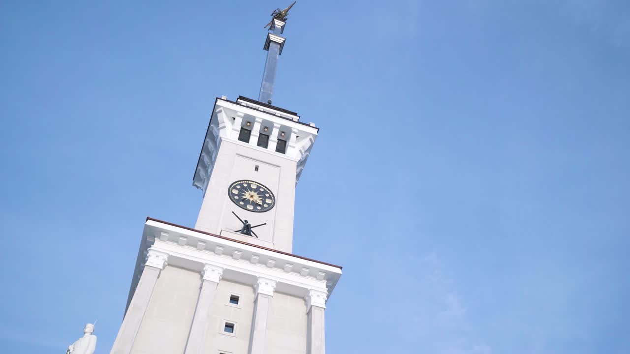 Tall White Clock Tower Under a Clear Sky