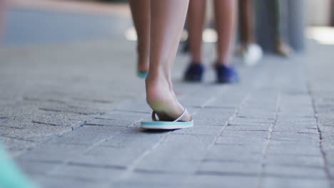 Feet of diverse schoolchildren standing in queue to get temperature measured