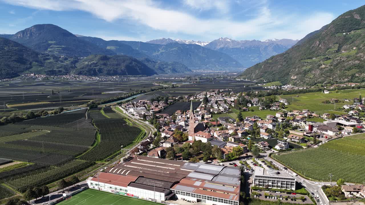 Chiesa Parrocchiale di Santa Maria Assunta in Terlano, small church surrounded by apple orchards. Aerial video