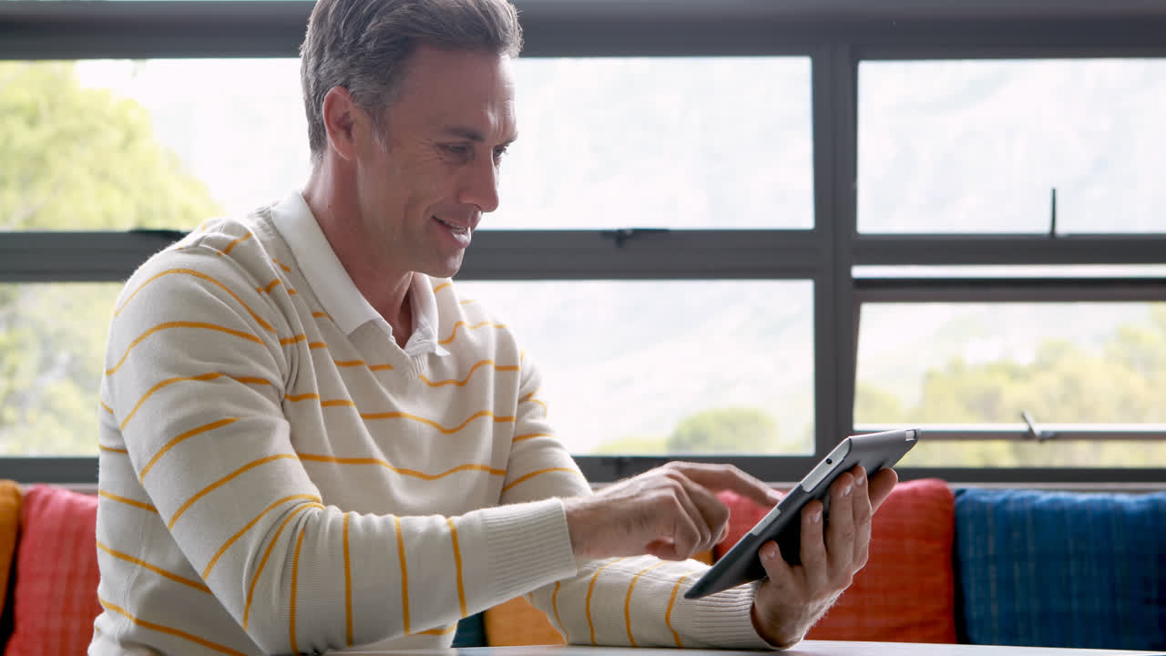 Male teacher using digital tablet