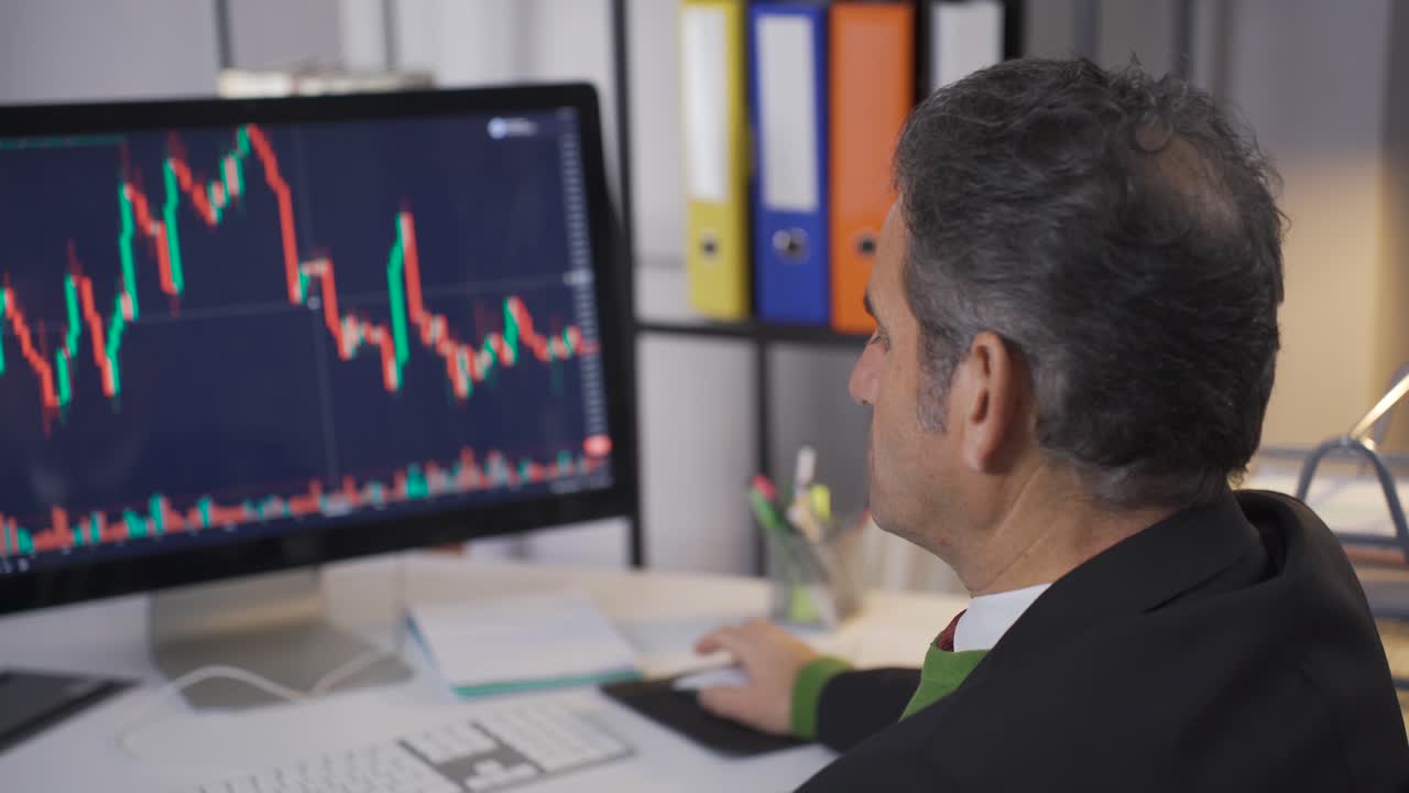 Thoughtful man researching and analyzing stock market data.