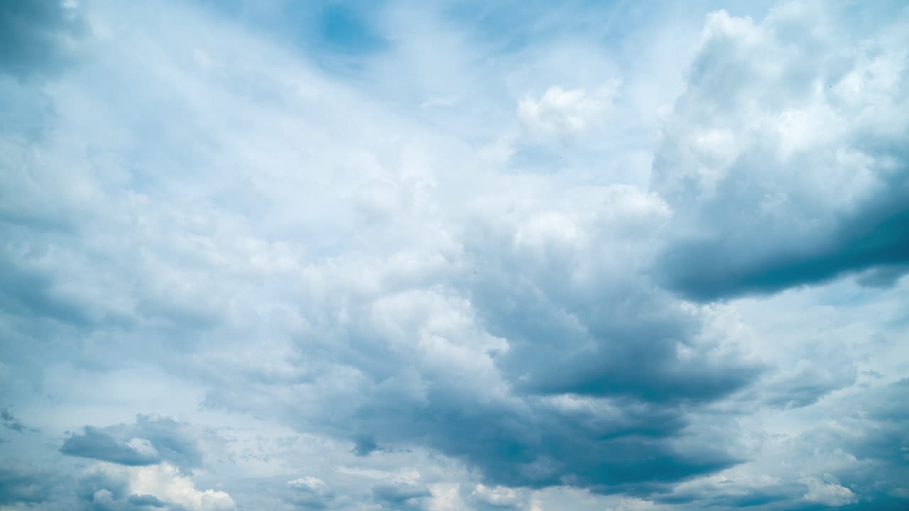 Rainy dark blue cumulus clouds. Rapid movement of cumulus clouds across the sky. Timelapse