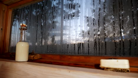 interior of finnish sauna, window view of a summer night in finland