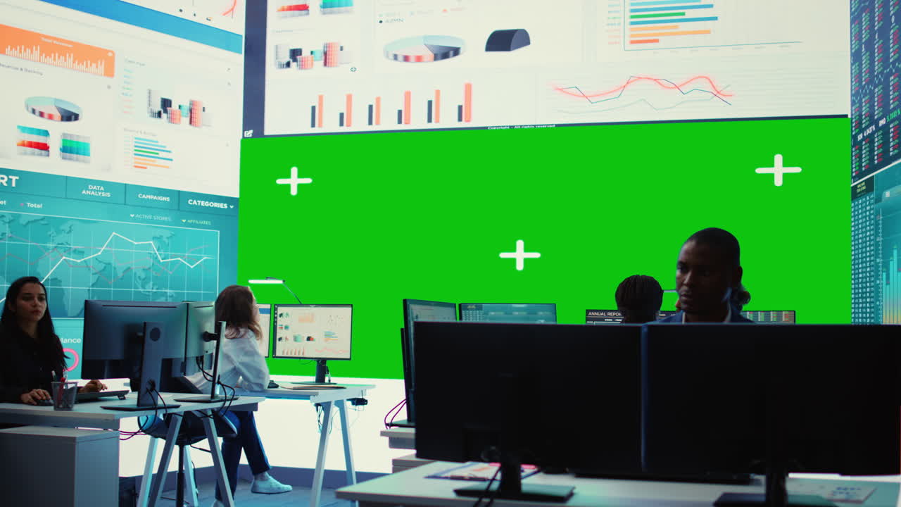 Diverse group of business specialists solve their daily tasks in control room