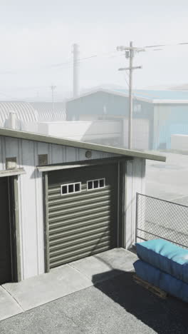 a grey garage door with a blue building in the background