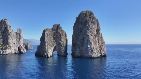 faraglioni of capri at naples in campania italy. coastal landscape. waterfront scene. faraglioni of capri at naples in campania italy. beach scenery. paradisiac seafront. capri island skyline.