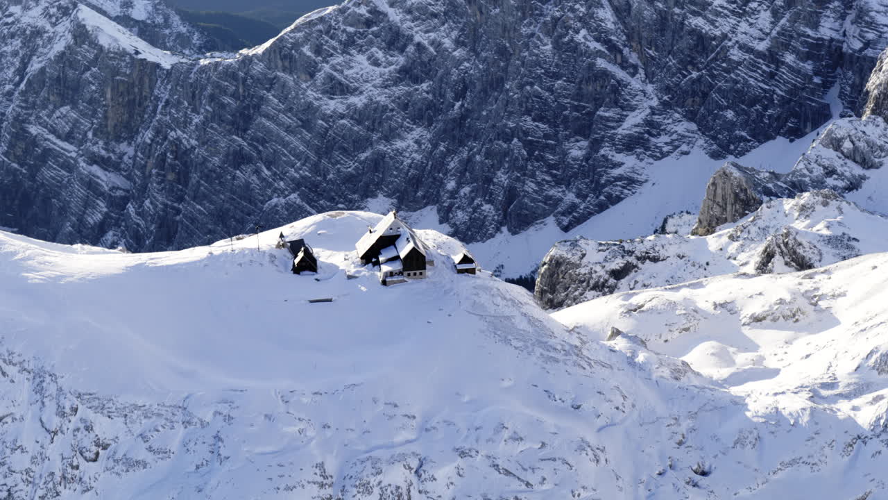 Snowy Alpine Hut on Mountain Peaks