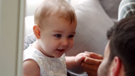 smiling baby girl with her father and mother