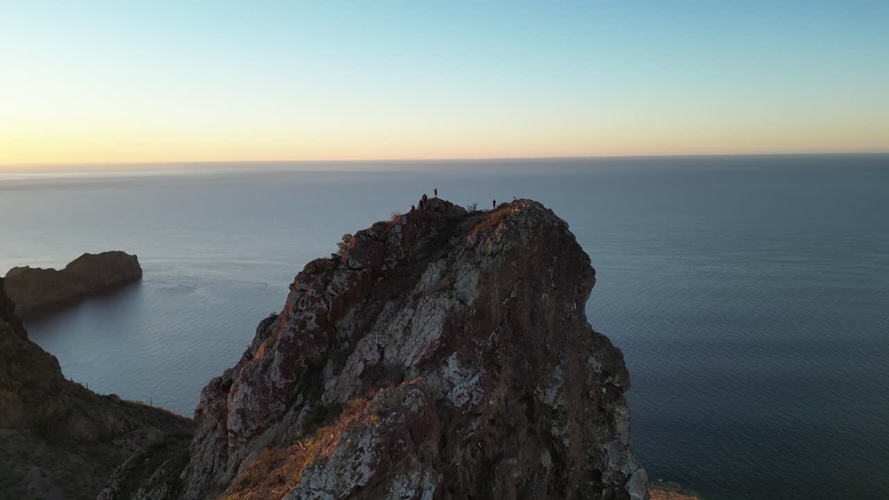 aerial shot of a mountain peak with people at the top 3