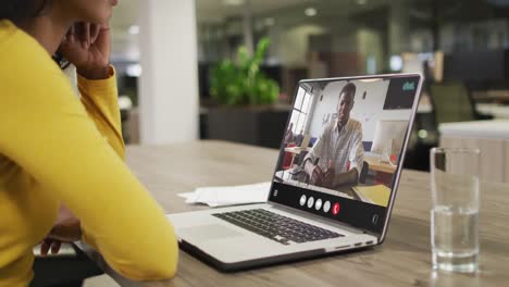 Animation-of-biracial-woman-having-video-call-on-laptop