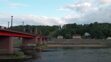 Time-lapse-of-a-Soviet-heritage-bridge-over-a-River-Nemunas-in-Kaunas-with-a-heavy-storm-clouds-moving-and-in-the-end-sun-illuminates-the-bridge