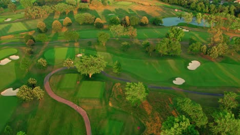 overview of a golf terrain, aerial revealing enormous size of the golf terrain in the evening