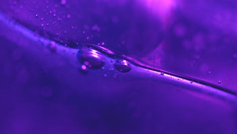 slow moving purple bubbles in abstract macro background