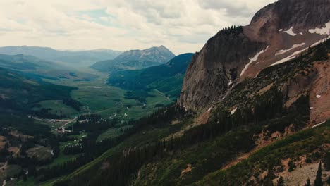 drone view of steep colorado mountain with gorgeous valley in the background