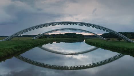 Flying-under-gas-pipes-running-across-calm-river-Morava-in-Slovakia