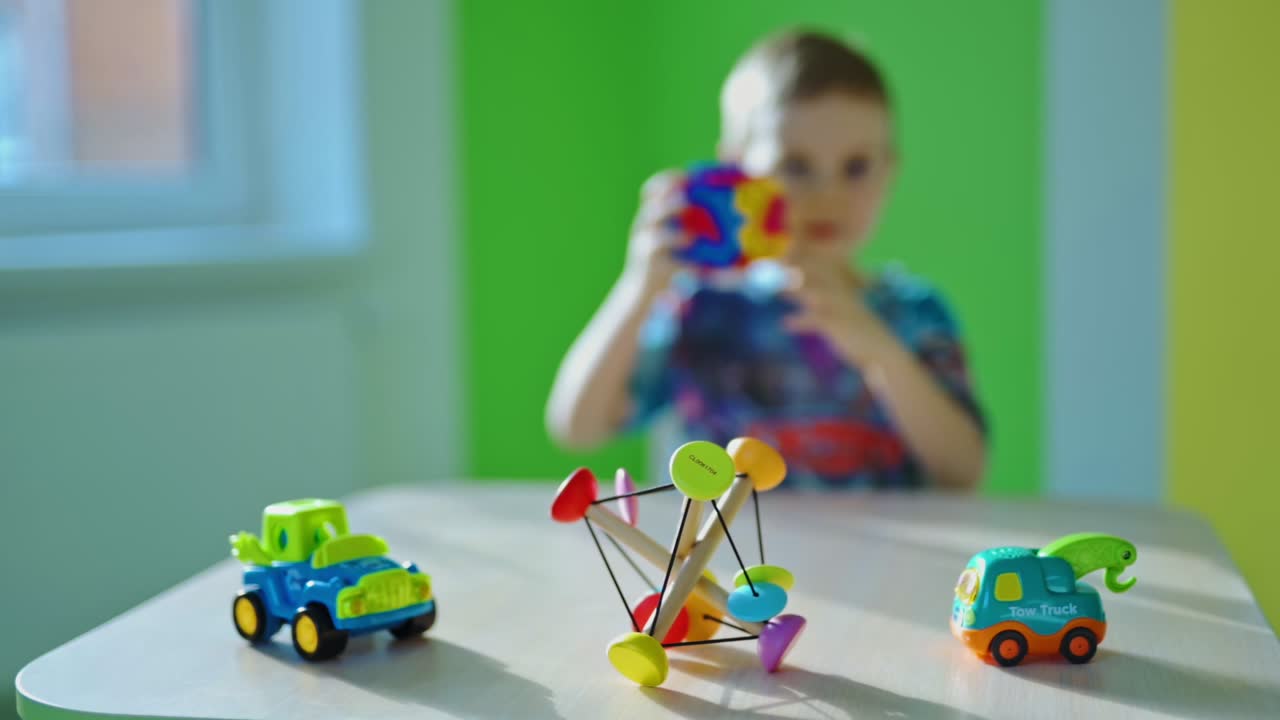 Boy playing with toys. Little boy is playing with toy at home