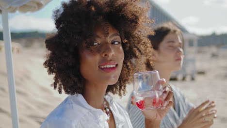 beautiful woman enjoying cocktail closeup. happy african american drinking soda