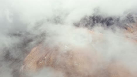 Drone-video-descending-above-clouds-top-peak-Mountain-church-monument-Kaimaktsalan