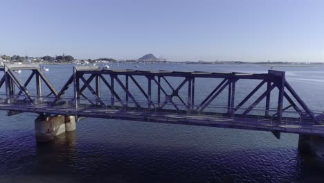 matapihi steel truss railroad bridge crossing water bay in tauranga, bay of plenty, aerial