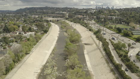 4k flight along the los angeles river in atwater with the five freeway and downtown la in the background