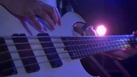 female musician tuning her guitar before concert