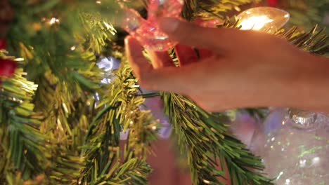 hanging pink crystal hummingbird ornament on decorated christmas tree